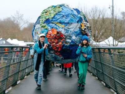 Green & HEalthy Frome Legacy read featuring photo of the Frome Youth Climate ACtion Group parading Frome with a globe made with plastic waste.